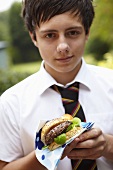 Schoolboy with hamburger