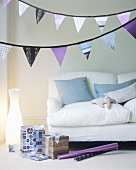 Christmas gifts, wrapping paper and garlands in sitting room