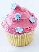 Cupcake with pink icing and sugar flowers