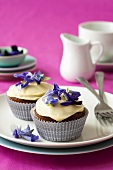 Carrot cupcakes with cream icing and edible flowers