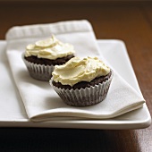 Two cupcakes on fabric napkin