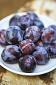 Fresh plums on plate