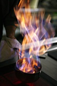 Flames in pan in commercial kitchen