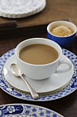 Instant coffee with milk in cup and saucer