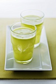 Two glasses of freshly pressed green apple juice