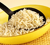 Cooked, long-grain rice in a bowl with a spoon