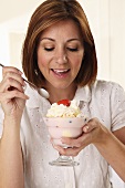 A woman eating a sundae