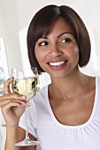 Woman holding glass of white wine