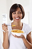 A woman eating cornflakes