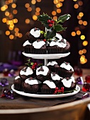 Christmas pudding muffins on a cake stand with holly