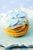 A whoopie pie decorated with blue hearts, stars and flowers