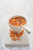 Red lentils in a bowl with a spoon