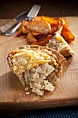 Homity Pied (vegetable pie, England), slice open, with potato wedges