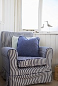 Blue striped chair in a room with a nautical theme