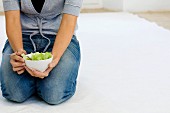 Woman holding a bowl of salad
