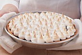 A fruit tart topped with meringue