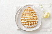 An egg-shaped almond biscuit with decorated with meringue