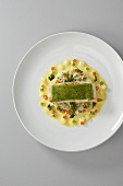 Brill fillet with a parsley crust on creamy vegetables
