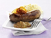 Sausage with mustard, onions and mashed potatoes