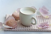A cup of milk and rose-flavoured macaroons