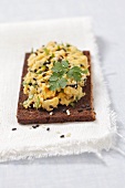 Pumpernickel topped with chickpea and coriander paste with sesame