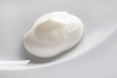 A dollop of yogurt on a white plate