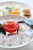 A jar of caviar on ice cubes