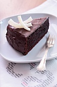A slice of chocolate cake with coconut