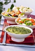 Four bowls of cooked, frozen vegetables
