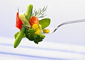 Cooked mixed vegetables on a fork