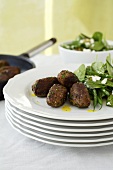 Herb meatballs with a spinach and bean salad and feta cheese