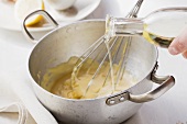Mayonnaise being made: oil being stirred into the egg-mustard mixture