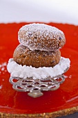 A Russian nut biscuit with vodka on a spoon with icing sugar