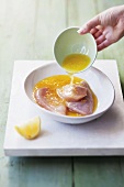 Chicken breast marinating in lemon marinade