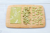 Home made spinach noodles on a cutting board