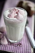 A glass of hot milk with marshmallows