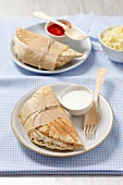 Pita bread with chicken and sauce and a cabbage salad