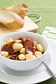 Gnocchi with salami and baguette