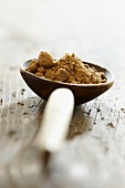 Natural brown sugar on a wooden spoon