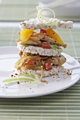 A tower of rice cakes, oranges and vegetables