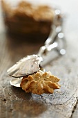 A spelt and anise biscuit with cake tongs