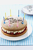 A birthday cake with strawberries and cream