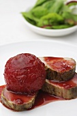 Fried pork fillet with plums and a mixed leaf salad