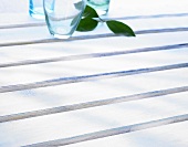 Empty glasses on white painted wooden boards