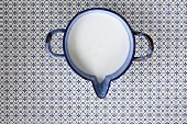 An enamel pot of milk (seen from above)