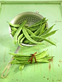 Green beans in a sieve and next to it