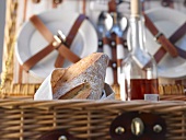 Bread and wine in a picnic basket