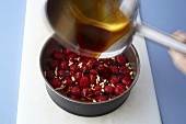 Caramel being poured over strawberries