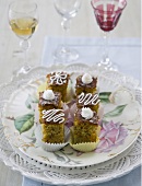 Several pieces of poppy seed cake on a plate with a decorative rose design