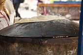 Unleavened bread being baked on a market stand